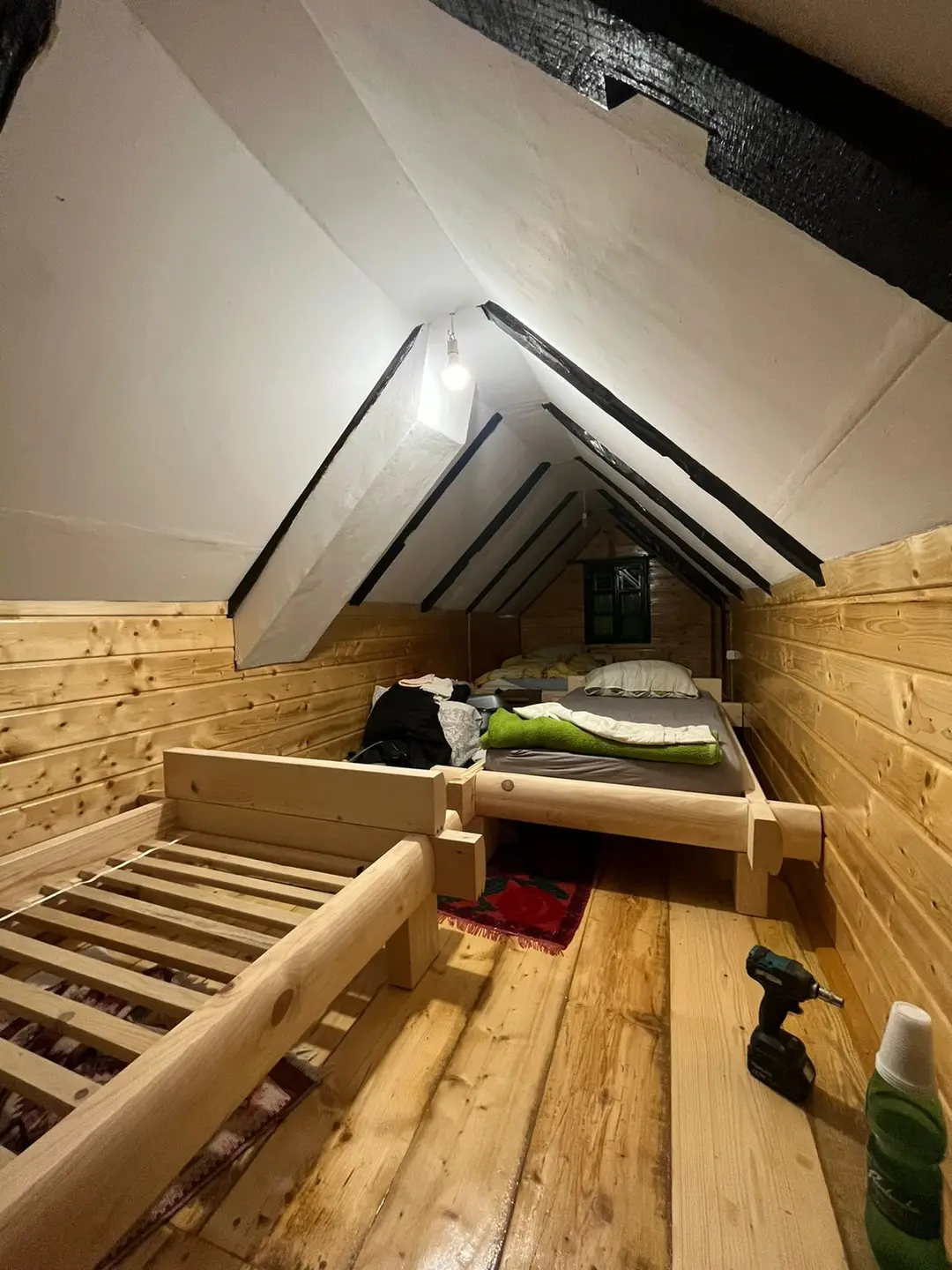 Sleeping gallery in the attic of an A-frame house, during finishing works