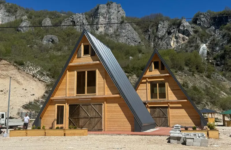 Pair of A-frame houses below the cliffs