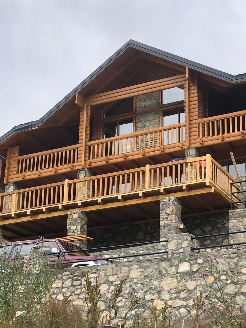 Log house on a stone ground floor with balconies