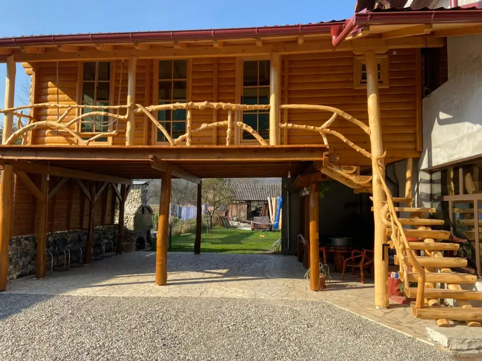 Log house on stilts with a staircase