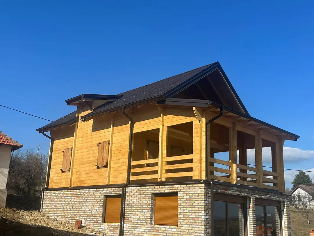 Finished log house with a covered terrace on a masonry ground floor
