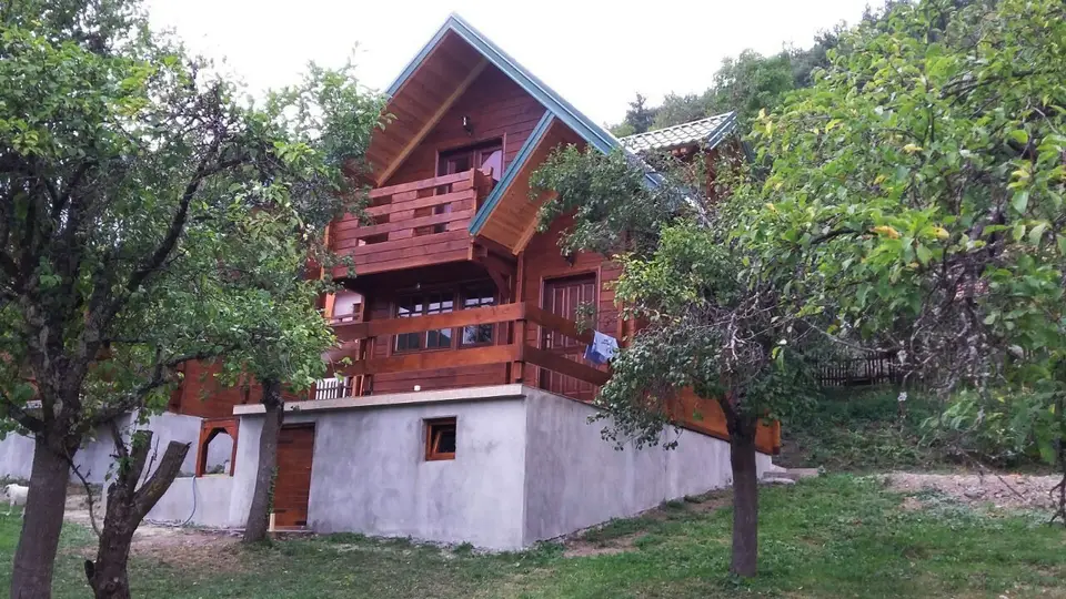 Red log house in an orchard