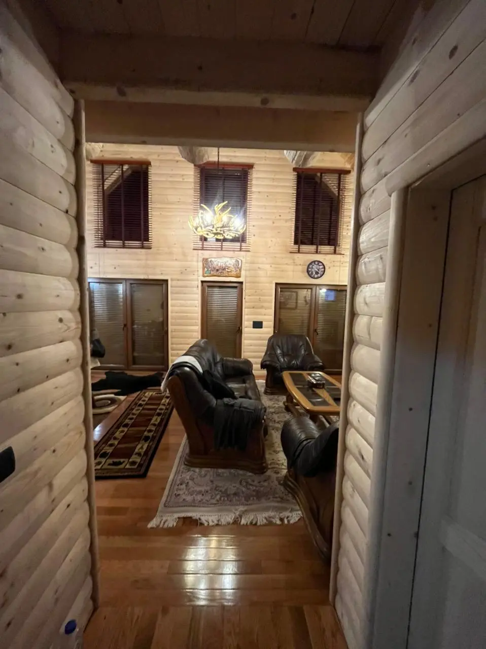 Log house interior with a gallery and fireplace