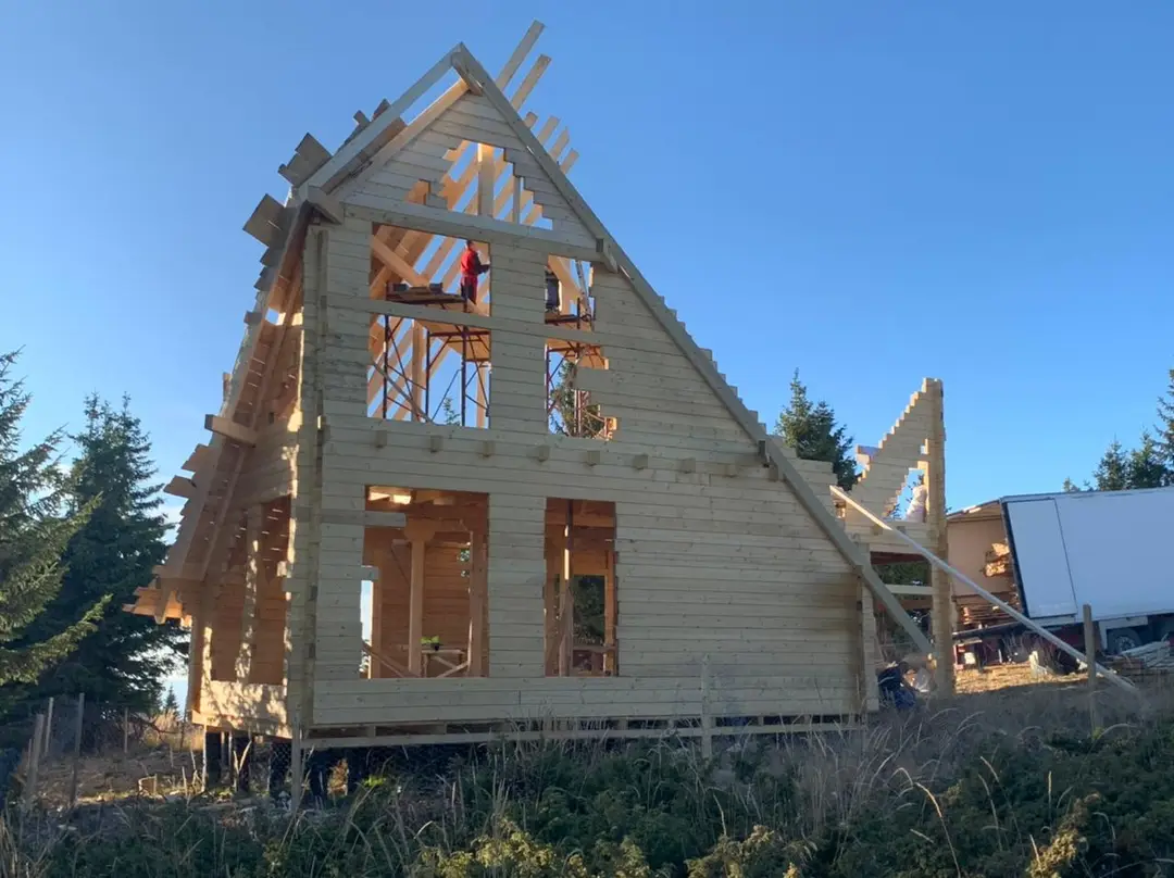 Timber frame of an A-frame house during assembly