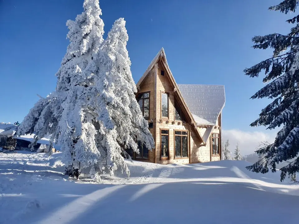 House with a glass gable in the snow