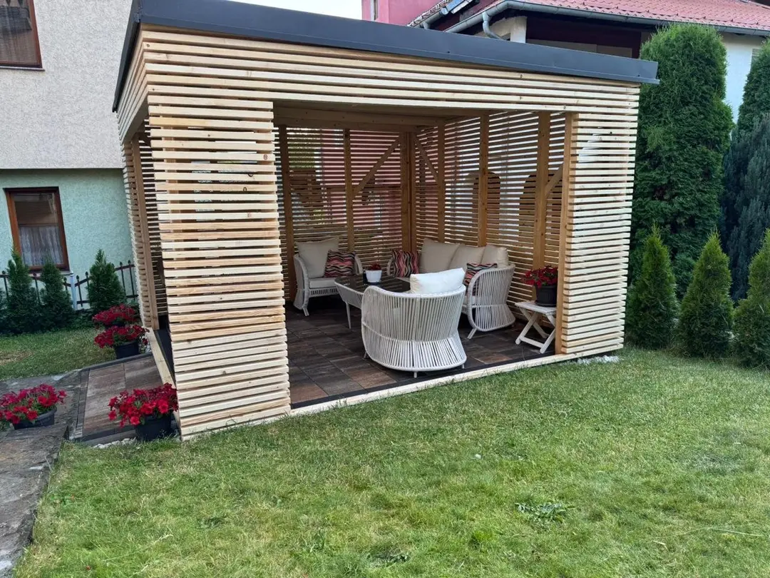 Wooden pergola of horizontal slats with garden furniture, side view