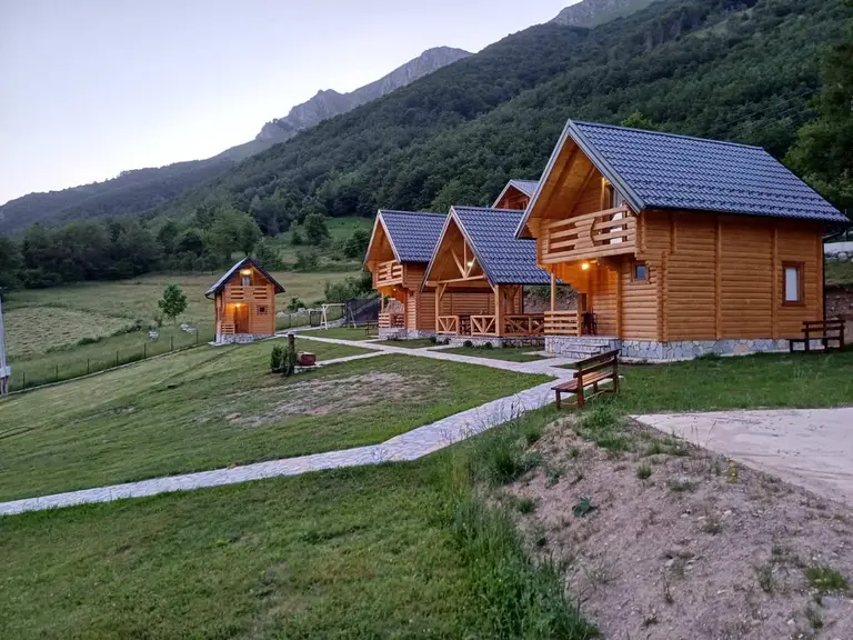 Cabins of the village below the mountain at dusk