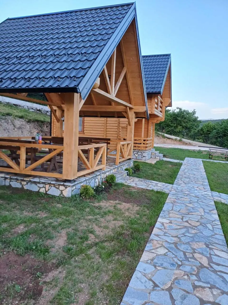 Log cabin with a porch and a stone path