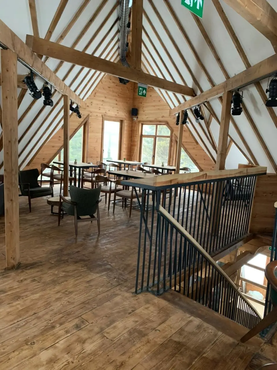 Restaurant gallery with a metal railing and timber beams