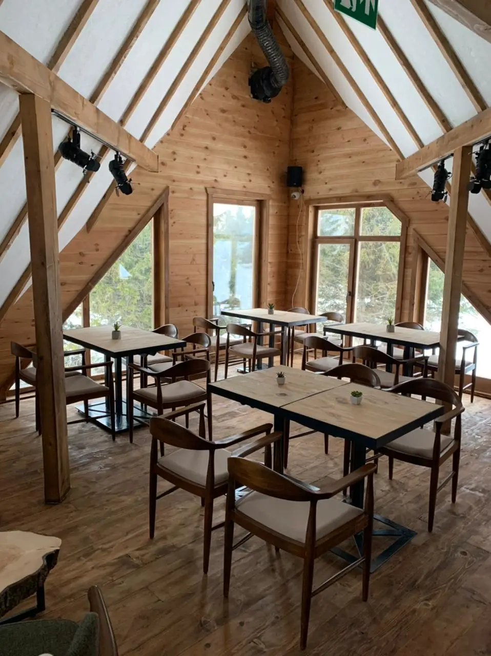 Tables by large windows in a timber restaurant