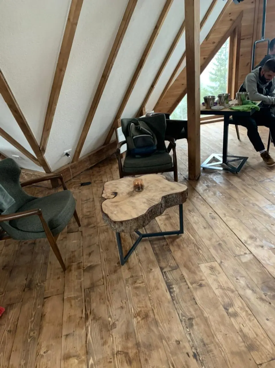 Seating corner with armchairs and a wooden table in the restaurant