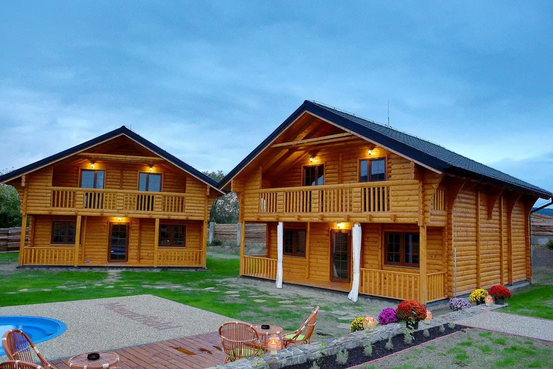 Two two-storey log houses by the pool in a holiday village
